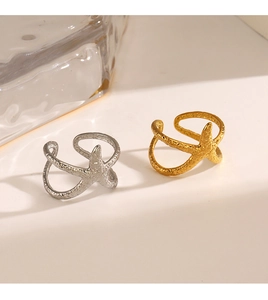 Detail of hammered texture on starfish-shaped gold and silver adjustable rings