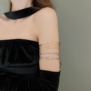 Detail of minimalist layered wrap metal arm cuff in gold and silver on model
