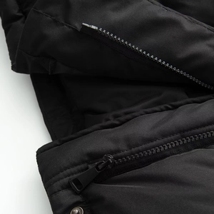 Close-up of a black waterproof jacket showing zipper detail and textured fabric