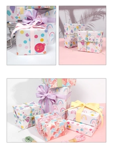 Detail of colorful polka dot and rainbow gift wrapping paper with ribbons and twine