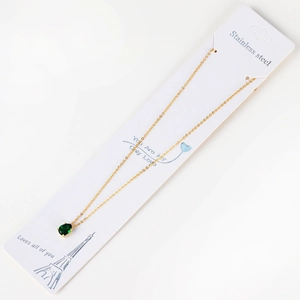 Macro shot of 18K gold plated stainless steel necklace with pear cut green zircon pendant