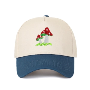 Detailed close-up of mushroom embroidery on a contrast panel cotton trucker hat