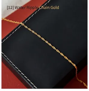 Close-up of golden water wave chain necklace on a black leather jewelry box