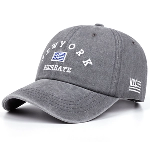 Detail of embroidered New York logo on washed dark gray vintage cotton baseball cap