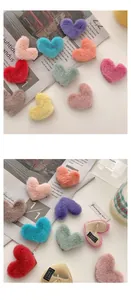 Detail showing plush heart hair clips with metal duckbill base and hand-made label