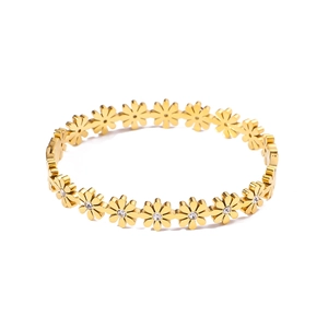 Detail shot of 18k gold plated daisy bracelet with sparkling crystals on white background