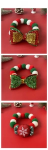 Detailed view of Christmas pet collars with sequins, plush pom-poms, and snowflake motifs