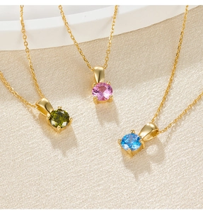Detailed shot of three sterling silver necklaces with green, pink, and blue cubic zirconia