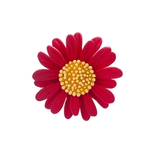 Close-up of a red enamel daisy flower brooch accessory with a polished metal center