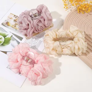 Detailed set of three elegant chiffon bow hair clips in cream, blush, and pink tones