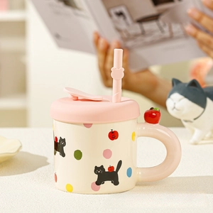 Close-up of cute ceramic cat mug with pink straw lid and cozy home afternoon tea vibes