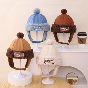 Winter bear earflap hats in multiple colors with Lucky bear patch and plush pom-poms