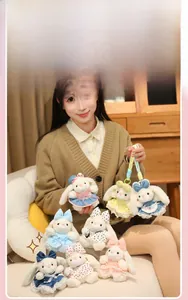 Detail view of plush bunny keychains in various colorful dresses and ribbon bows