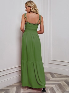 Detail of cross-back tie straps and ruffled back on a green summer beach maxi dress