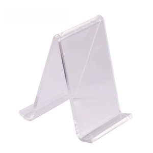 Minimalist clear acrylic stand for silicone ear model display on white background