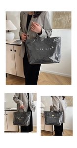 Close-up of black glossy tote bag with white TOTE BAG text print for minimalist style