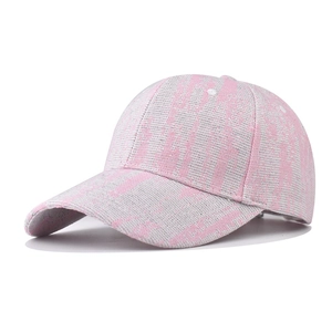Close-up of pink and grey checkered baseball cap showing fabric texture and curved brim