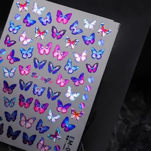 Golden foil butterfly nail stickers with laser holographic gradient patterns on black background