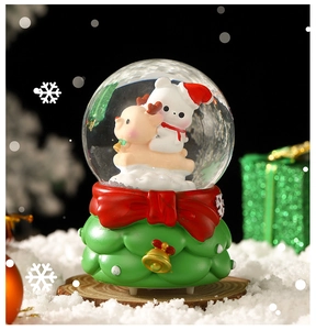 Detailed view of Christmas snow globe with polar bear, reindeer and festive green base