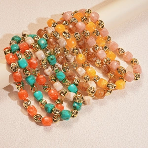 Detailed macro view of colorful acrylic square beads and gold irregular metal spacers