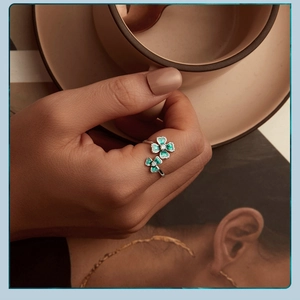 Adjustable silver ring with green enamel four-leaf clover design and zircon accents
