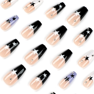 Press-on coffin nails with black french tips, white stars, and purple accents set