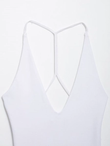 Detailed top view of white ribbed knit bodysuit with deep V-neck and thin shoulder straps