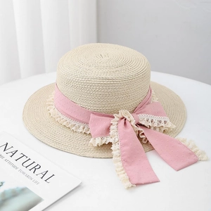 Flat top straw boater hat with pink lace ribbon and bow for summer beach sun protection