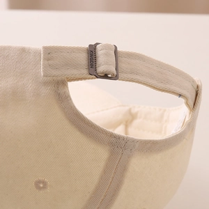 Detail of adjustable metal buckle and premium twill cotton fabric on children's baseball cap