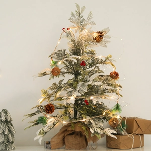 Tabletop Christmas tree with pine cones, red berries, LED lights and burlap base