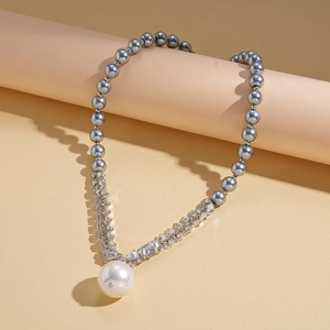 Detail of luxury necklace with grey glass beads, crystal accents and a large pearl pendant