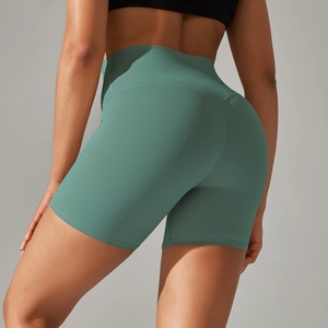 Detail showing the contouring fit and double-sided brushed fabric of green yoga shorts