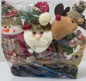 Detail view of plush Christmas doll set in transparent plastic packaging wrap