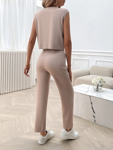 Rear view of a beige ribbed knit two-piece set featuring sleeveless top and long trousers