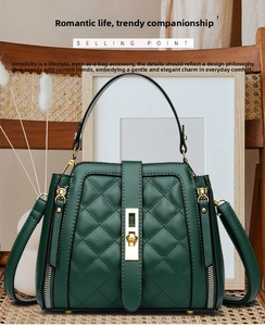 Detail of dark green quilted handbag with golden twist lock on a vintage wooden chair