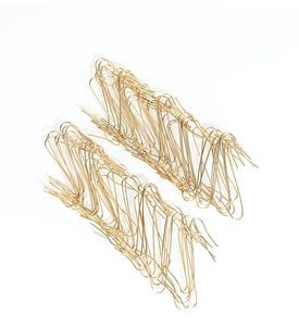 Pile of gold S-shaped Christmas tree ornament hooks on a clean white background