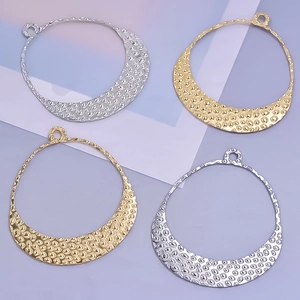 Detailed view of hammered moon pendants in gold and silver finish for custom jewelry
