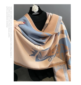 Detail view of crown pattern on soft cashmere-feel scarf draped on a mannequin