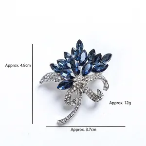 Elegant silver blue crystal flower brooch with bowknot detail and pearl accent