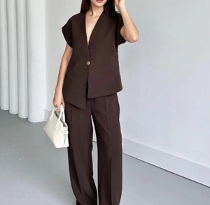 Detailed view of dark brown two-piece set featuring V-neck vest and wide-leg trousers