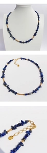 Macro shot of blue lapis lazuli beads and baroque pearl necklace with golden clasp