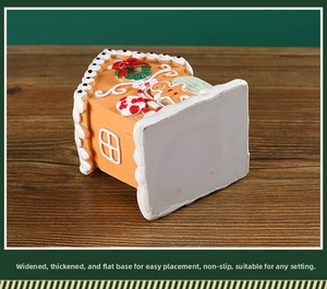 Close-up of the widened flat base of a resin gingerbread house Christmas ornament