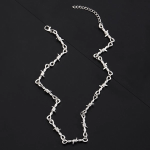Detailed view of silver barbed wire design necklace with lobster clasp and chain links