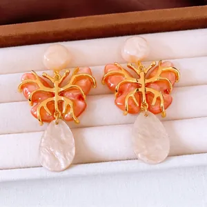 Vintage butterfly resin drop earrings with hollow gold frame and coral orange accents