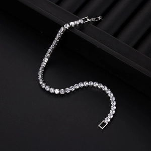 Detail of silver tennis bracelet with clear zircon stones on a black display tray