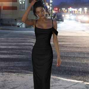 Detail of elegant black bodycon maxi dress featuring thin straps and ruched side design