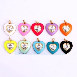 Macro view of ten colorful enamel heart charms with white crystals for jewelry making