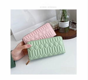Close-up of long quilted PU leather wallets with zipper closure and diamond pattern
