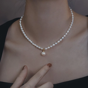 Minimalist freshwater pearl necklace with white irregular pearls and gold bead pendant