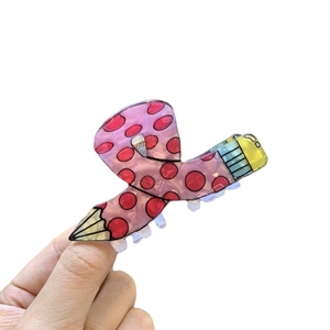 Pink pencil shaped acrylic hair claw clip with red polka dots for cute styling